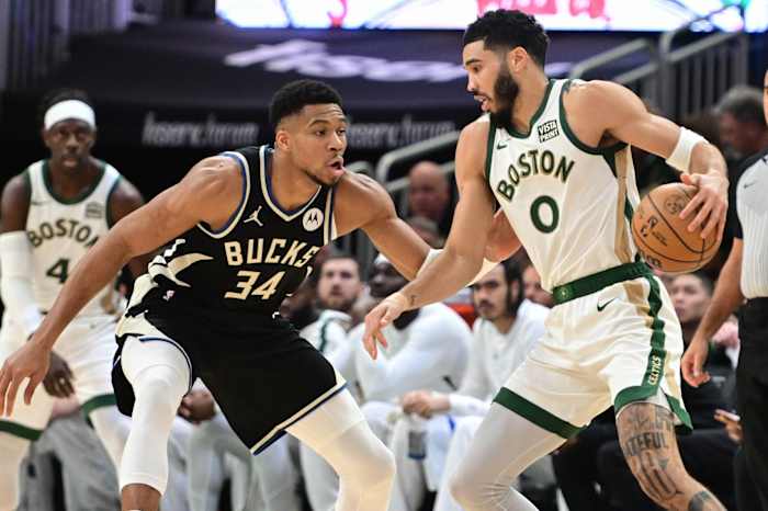 Boston Celtics forward Jayson Tatum (0) drives for the basket against Milwaukee Bucks forward Giannis Antetokounmpo (34)